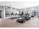 Well-equipped gym featuring modern cardio machines with a lake themed wall art at 6365 Ashton Park Dr, Denver, NC 28037