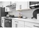 Modern kitchen featuring white cabinets, stainless steel appliances, and sleek countertops at 6365 Ashton Park Dr, Denver, NC 28037
