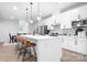 Bright, open kitchen featuring a large island with seating, stainless steel appliances, and modern pendant lighting at 6365 Ashton Park Dr, Denver, NC 28037