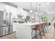 Bright modern kitchen featuring white cabinets, stainless steel appliances, and a large island with seating at 6365 Ashton Park Dr, Denver, NC 28037