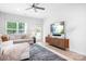 Bright living room featuring a ceiling fan, modern console, and a comfortable sectional sofa with large windows at 6365 Ashton Park Dr, Denver, NC 28037