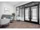 Modern lobby area with comfortable seating and black framed glass entryway and wood look floors at 6365 Ashton Park Dr, Denver, NC 28037