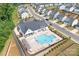 Aerial view of community pool and clubhouse with lounge chairs and green landscaping at 6365 Ashton Park Dr, Denver, NC 28037