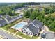 Aerial view showcasing a community pool area, clubhouse, and well-manicured landscaping at 6365 Ashton Park Dr, Denver, NC 28037