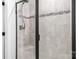 Modern tiled shower with sleek black framed glass door and built-in bench for a spa-like experience at 6365 Ashton Park Dr, Denver, NC 28037