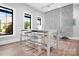Modern work area featuring a long table with seating for six and bright natural light at 6365 Ashton Park Dr, Denver, NC 28037