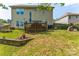 Large, grassy backyard with a wooden deck, grill, and tasteful landscaping, perfect for outdoor entertaining at 6412 Bluegill Rd, Charlotte, NC 28216