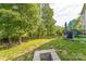Spacious backyard with lush greenery, mature trees, fire pit and a wooden fence at 6412 Bluegill Rd, Charlotte, NC 28216