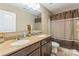 Bathroom features a double sink vanity, large mirror, and shower-tub combination with a stylish curtain at 6412 Bluegill Rd, Charlotte, NC 28216