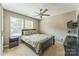 Bright bedroom featuring a ceiling fan, large windows, and a dark wood dresser at 6412 Bluegill Rd, Charlotte, NC 28216