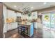 Modern kitchen featuring an island, white cabinets, stainless appliances, and an adjacent door to the outdoor deck at 6412 Bluegill Rd, Charlotte, NC 28216
