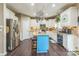 Bright kitchen featuring an island with seating, white cabinets, and stainless-steel appliances for meal prep at 6412 Bluegill Rd, Charlotte, NC 28216