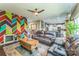 Open-concept living room featuring a colorful accent wall and views of the kitchen and dining area at 6412 Bluegill Rd, Charlotte, NC 28216