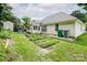 The backyard is in need of a lawn care specialist. The lawn is patchy, there are weeds, and standing water at 6414 Goldenblush Cir, Charlotte, NC 28269