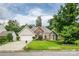 Charming brick and vinyl home featuring a lush, well-manicured lawn and mature trees at 6414 Goldenblush Cir, Charlotte, NC 28269