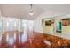 Open-concept living space featuring hardwood floors, vaulted ceiling, and views into the kitchen at 6414 Goldenblush Cir, Charlotte, NC 28269