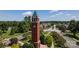 Aerial view of clock tower amidst lush landscaping and neighborhood streets, highlighting community charm at 6711 Creft Cir, Lake Park, NC 28079