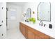 Bright bathroom with double sink vanity, quartz countertop, modern faucets, and large arched mirrors at 6711 Creft Cir, Lake Park, NC 28079