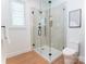 Bright bathroom with a glass-enclosed shower, white tiles, and minimalist design at 6711 Creft Cir, Lake Park, NC 28079
