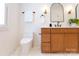 Bright bathroom featuring double sink vanity with quartz countertop, modern faucet, and arched mirror at 6711 Creft Cir, Lake Park, NC 28079