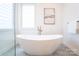 Bright bathroom with a soaking tub and large picture window at 6711 Creft Cir, Lake Park, NC 28079