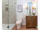 Modern bathroom featuring a glass-enclosed shower and stylish vanity with black fixtures and wooden accents at 6711 Creft Cir, Lake Park, NC 28079