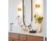 Close up on a modern bathroom vanity with elegant light fixtures and decor at 6711 Creft Cir, Lake Park, NC 28079
