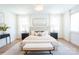 Bright bedroom with hardwood floors, neutral color palette and a tufted headboard at 6711 Creft Cir, Lake Park, NC 28079