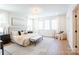 Spacious primary bedroom with hardwood floors, many windows, and a neutral color palette at 6711 Creft Cir, Lake Park, NC 28079