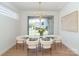 Bright dining room with modern chandelier, glass table, seating for six, and a large window at 6711 Creft Cir, Lake Park, NC 28079