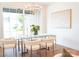 Bright dining room with a modern chandelier, glass table, and seating for six at 6711 Creft Cir, Lake Park, NC 28079