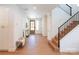 Bright and airy entryway with wood floors, a staircase, and stylish decor setting an inviting tone at 6711 Creft Cir, Lake Park, NC 28079