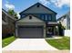 Exterior featuring a large garage with a driveway and well-maintained lawn, providing ample parking at 6711 Creft Cir, Lake Park, NC 28079