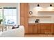 Modern kitchen featuring custom wood cabinets, tile backsplash, and open shelving adjacent to the living area at 6711 Creft Cir, Lake Park, NC 28079