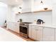 Modern kitchen with a stainless steel stove, white countertops and cabinets, and gold hardware at 6711 Creft Cir, Lake Park, NC 28079