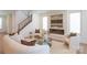 Bright living room with fireplace, stairs, and neutral-toned furniture for a cozy atmosphere at 6711 Creft Cir, Lake Park, NC 28079