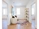 Bright sitting room featuring white walls, accent rug, stylish decor, and wood floors at 6711 Creft Cir, Lake Park, NC 28079