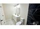 Modern bathroom features double vanity, new fixtures, and sleek, dark tile at 703 Central Nw Dr, Concord, NC 28027