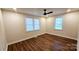Neutral bedroom features sleek flooring, modern ceiling fan, and lots of natural light at 703 Central Nw Dr, Concord, NC 28027