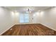 Bright living room features sleek flooring, modern ceiling fan, and lots of natural light at 703 Central Nw Dr, Concord, NC 28027