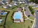 Aerial view of a community pool with surrounding homes, parking and landscaping at 7150 Irongate Dr, Indian Land, SC 29707