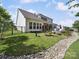 Landscaped backyard featuring a stone pathway, fenced yard, and patio area at 7150 Irongate Dr, Indian Land, SC 29707
