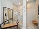Modern bathroom featuring a walk in shower with neutral tile surround, a mirror and vanity seating at 7150 Irongate Dr, Indian Land, SC 29707