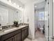 Bright bathroom with double sinks, granite countertops, and an open shower at 7150 Irongate Dr, Indian Land, SC 29707