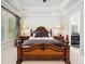 Primary suite showcasing a trey ceiling, carpeted floors and two bedside lamps with ornate decor at 7150 Irongate Dr, Indian Land, SC 29707