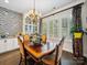 Elegant dining room with hardwood floors, designer chandelier, and natural light from large windows at 7150 Irongate Dr, Indian Land, SC 29707