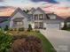 Stunning two-story home boasts a well-manicured lawn, elegant trim, and a three-car garage at 7150 Irongate Dr, Indian Land, SC 29707