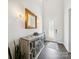 Elegant foyer with a decorative mirror, stylish console table, and hardwood floors at 7150 Irongate Dr, Indian Land, SC 29707