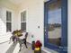 Charming front porch with a cozy seating area and a stylish blue front door at 7150 Irongate Dr, Indian Land, SC 29707