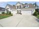 Lovely home with a three-car garage and a classic white exterior at 7150 Irongate Dr, Indian Land, SC 29707